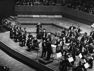 JP with the London Mozart Players at a concert at the Royal Festival Hall in 1970, with conductor Harry Blech congratulating legendary bassoon-player Archie Camden on his 80th birthday. JP and 2nd horn Peter Clack mid-back-right behind woodwinds.